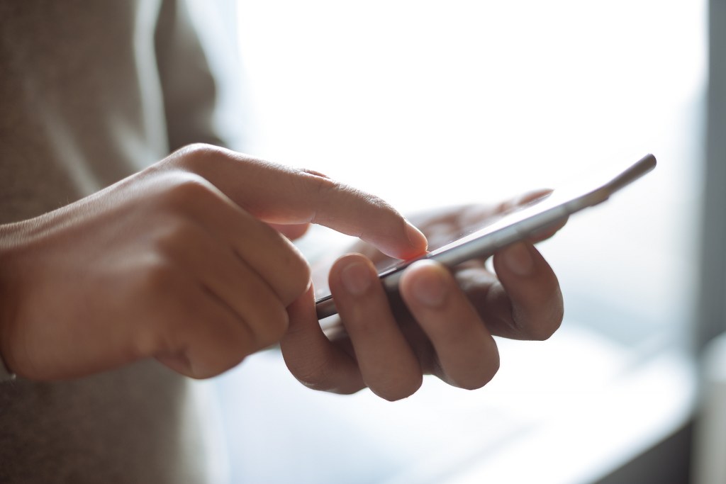 User hands interacting with phone.