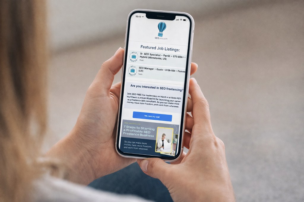 A person viewed from behind browsing SEO job listings on a smartphone screen.