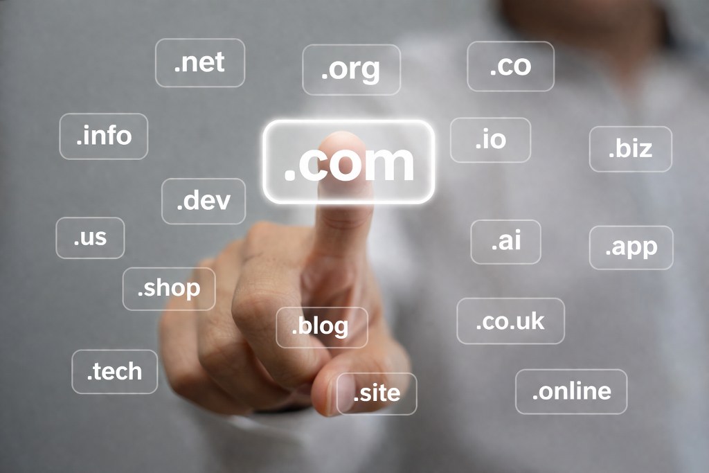 Finger selecting a glowing domain among floating options.