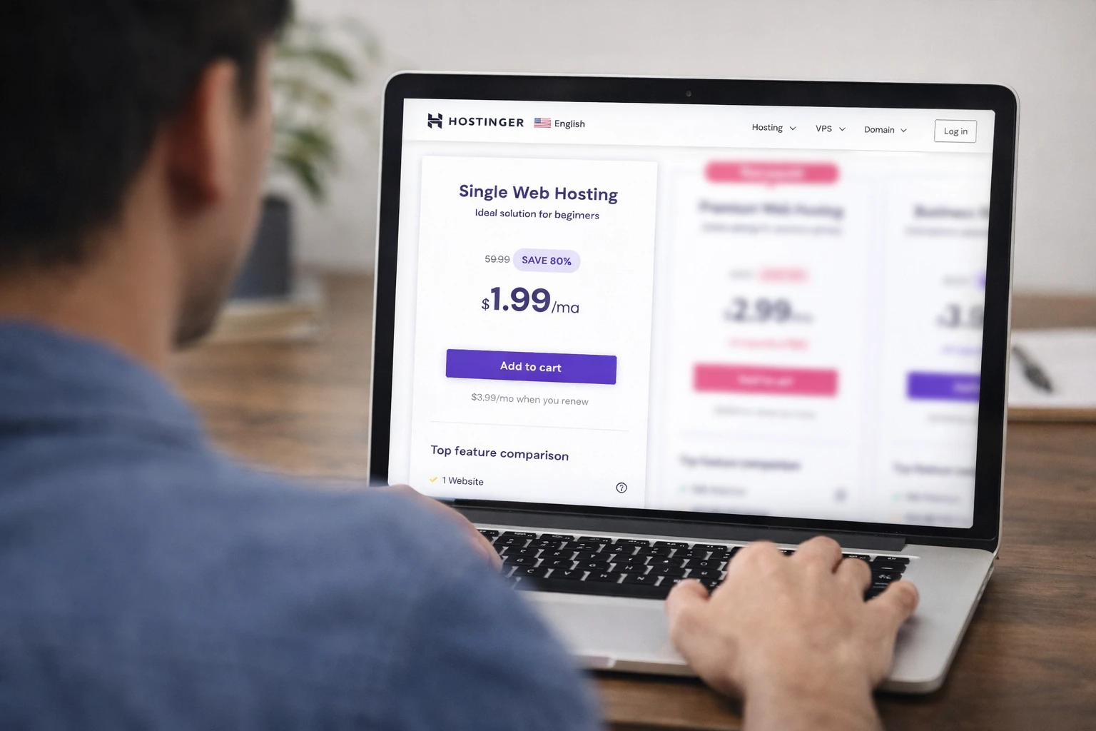 A person views hosting pricing on a laptop, considering a purchase.