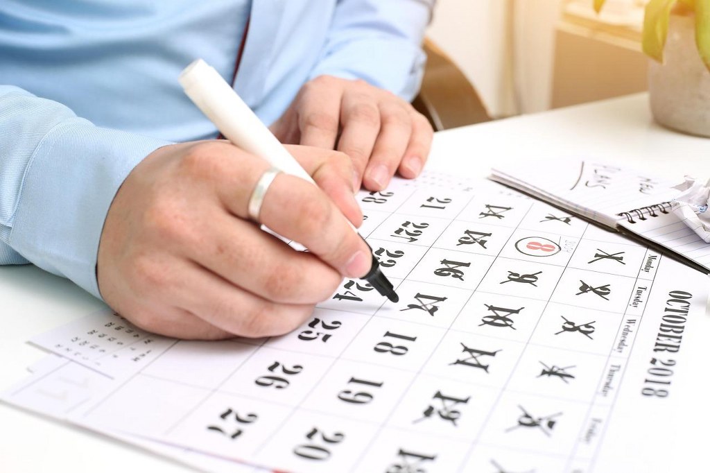 Making a schedule on a calendar.