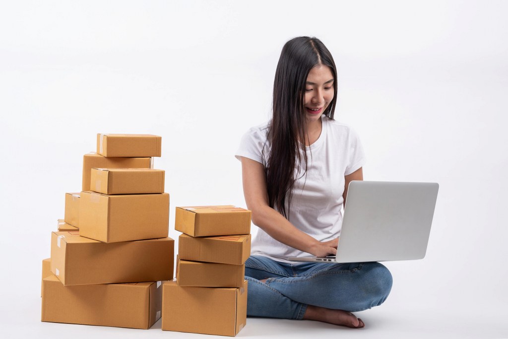 A supply chain manager looking at stock availability on her laptop.