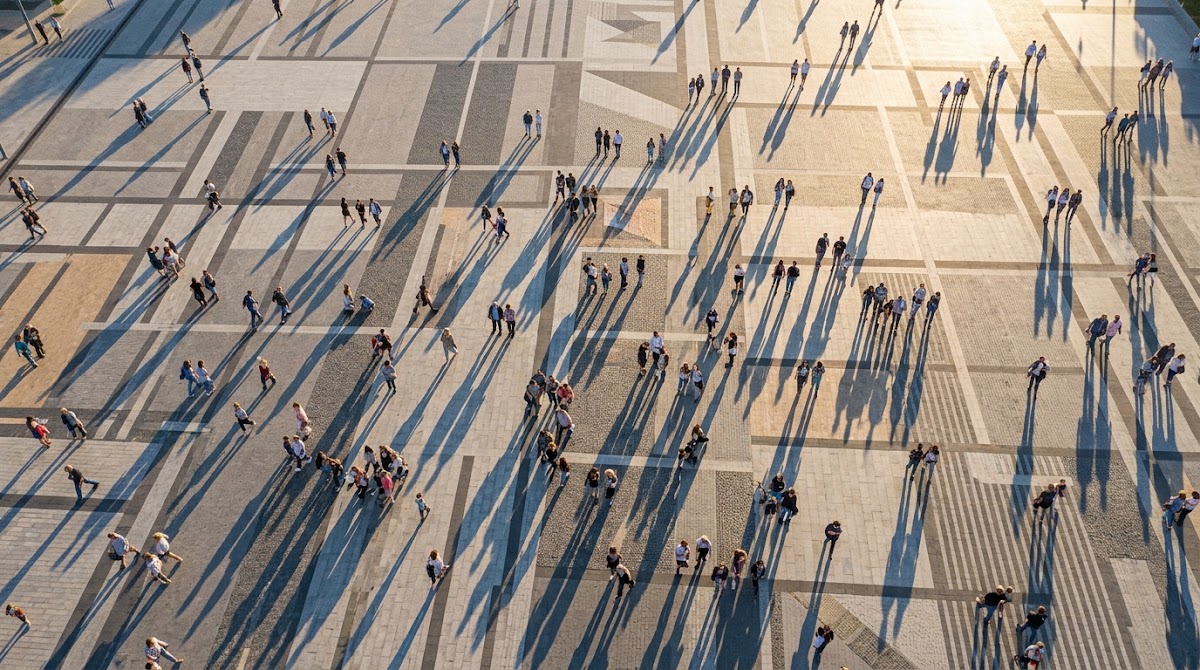 Aerial view of people walking through a busy public square