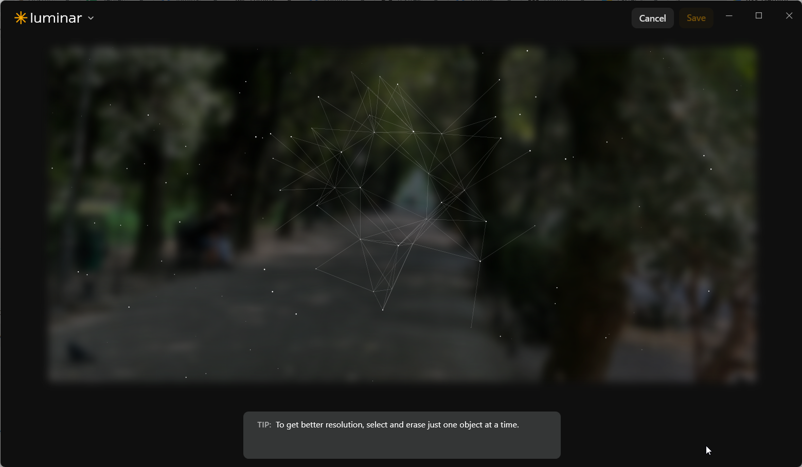 Luminar Neo generative erase processing screen showing a blurred walkway and a tip to erase one object at a time for better resolution.